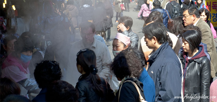 A crowd of hungry people wait to buy the famous hot mandu dumplings. Namdaemun Market, Seoul, South Korea