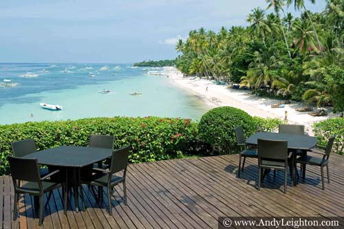 Amorita Resort wooden decking and tables overlook the Alona Beach. Panglao Island, Philippines