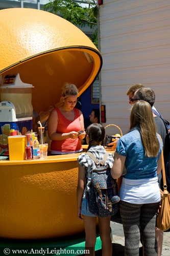 Customers wait for a glass of fresh orange juice from a large orange shaped stall. Chinese New Year 2013, Northbridge, Perth, Australia